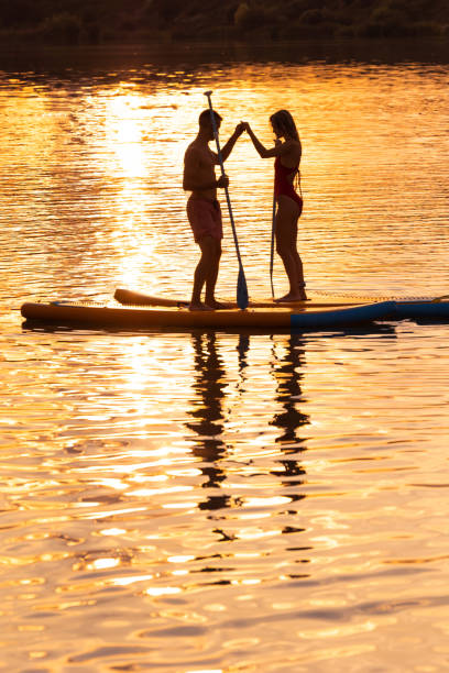 istock Sea woman and man on sup board have active rest. 1652308416