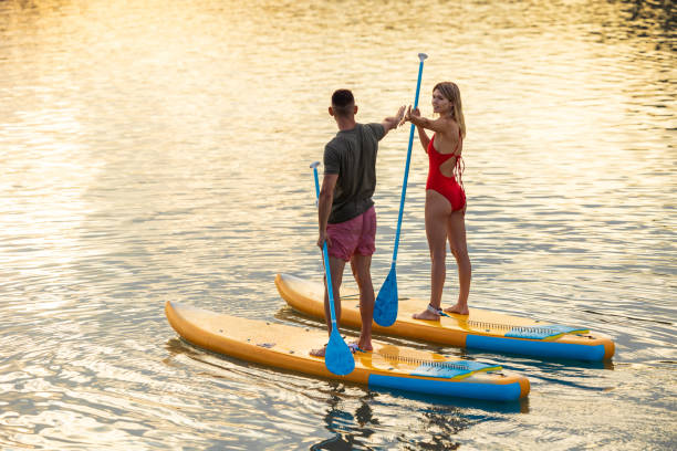 istock Man and woman with athletic body on surf board on river. 1652309167