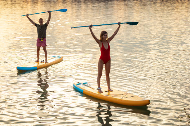 istock Male and female during paddleboarding at sunset. 1652309433