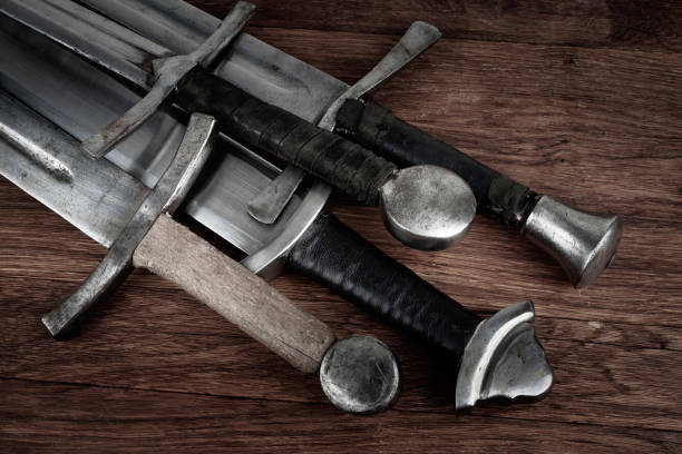 istock Medieval swords on wooden backgrond. 1652322959