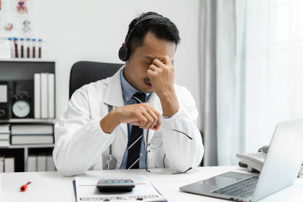 istock Doctor eyestrain fatigued from computer work, stressed man suffer from headache bad vision sight problem sit at office table using laptop. 1652323331