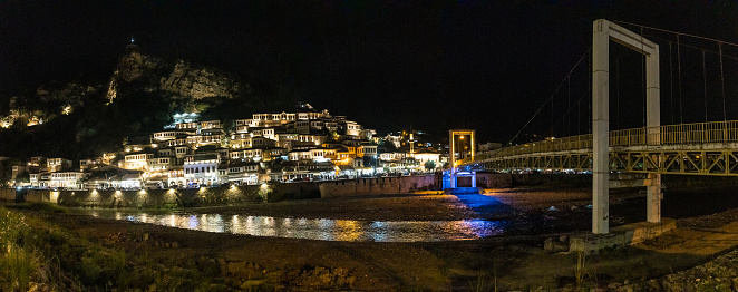 Panoramic of the illuminated historic city of Berat in Albania and its bridge on the river, UNESCO, the city of a thousand windows