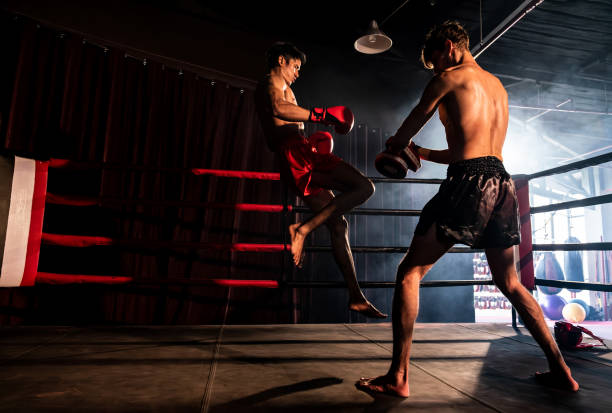 istock Asian and Caucasian Boxer unleash knee attack in training. Impetus 1652355191