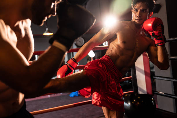 istock Asian and Caucasian Boxer unleash kick attack. Impetus 1652360651