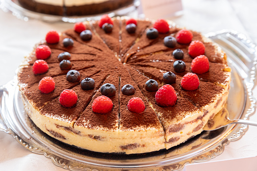 Tiramisu cake with raspberries  Traditional Italian dessert.