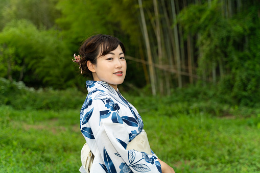 A woman in a yukata standing in a mountain village