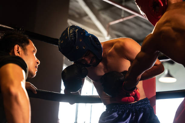 istock Boxer fighter competitor struggle and get disadvantage on boxing match. Impetus 1652372732