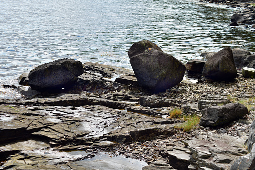 Close up of boulders on rugged beach in Horten, Norway. Coastal horizontal photo with copy space.