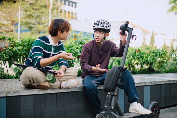 istock Two Asian Chinese young men talking about scooter. 1652378251