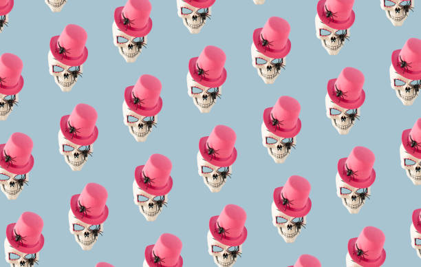 Sugar skull mask with spiders and pink hat on blue background. Minimal Halloween concept.