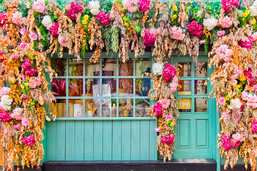 Multi colored flower craft tapestry, springtime  store window and street decoration . Astorga, León province, Castilla y León, Spain .