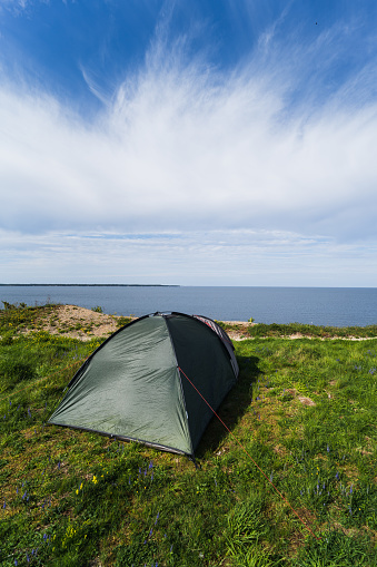 Tent on the shore of the Baltic Sea in Paldiski on a summer day. Vertical photo. High quality photo