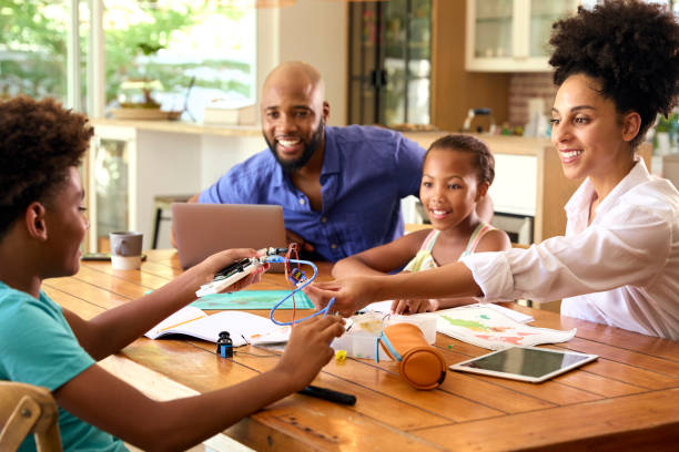 istock Family Around Table At Home Using Laptop With Parents Helping Children With Science Homework 1652440885