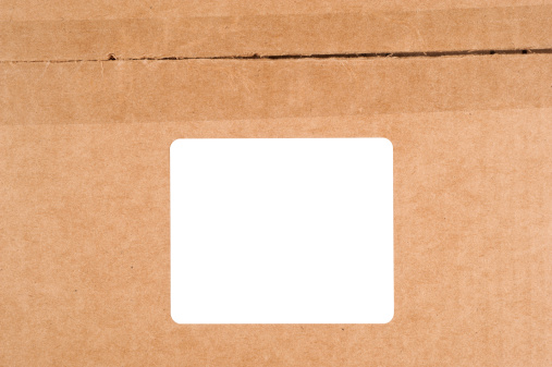 A blank white label on a cardboard box.  Users can add copy to the blank label.