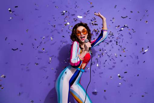 Photo of cute adorable girl dressed striped overall dark eyewear dancing disco singing songs isolated violet color background.