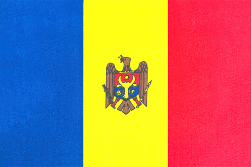 the national flag of Moldova on a fabric basis in close-up
