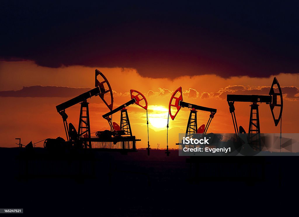 Oil field at sunset. Collage. Oil field at sunset. Crude Oil Stock Photo