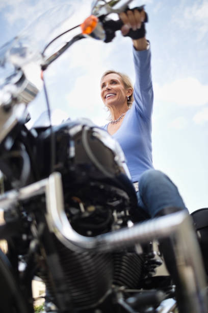 istock Woman Riding Motorcycle Against Cloud Sky 165247605