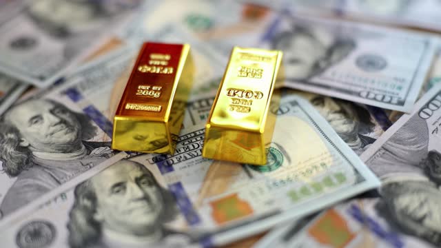 Expensive gold bar and US dollar banknotes