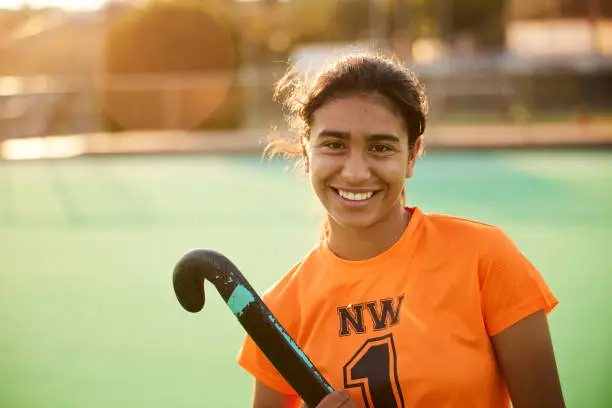 Photo of Confident Gaze: Teen Female Hockey Player Exudes Self-Assuredness