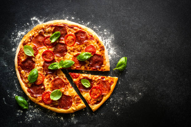 istock Traditional italian pizza with salami cheese, tomatoes and basil. 1652498486