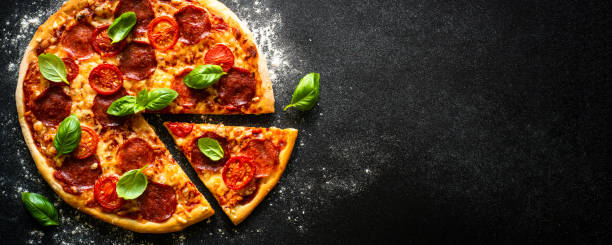 istock Traditional italian pizza with salami cheese, tomatoes and basil. 1652498564