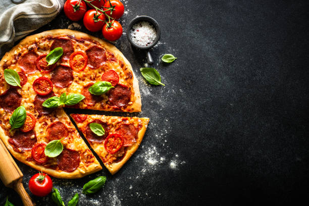 istock Traditional italian pizza with salami cheese, tomatoes and basil. 1652498690