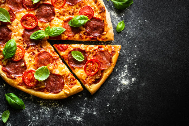 istock Traditional italian pizza with salami cheese, tomatoes and basil. 1652499227