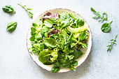 Green salad, Fresh salad leaves and vegetables in white plate.