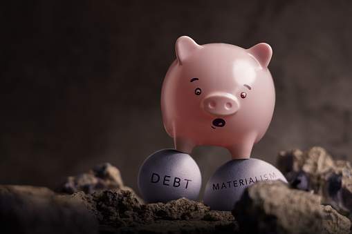 Enemies of Financial Success Concepts. Economic and Savings Crisis. a Pink Piggy Bank in Shocked Face on Unstable Ball of Debt  and Materialism. trying to pass through on the Rough Road