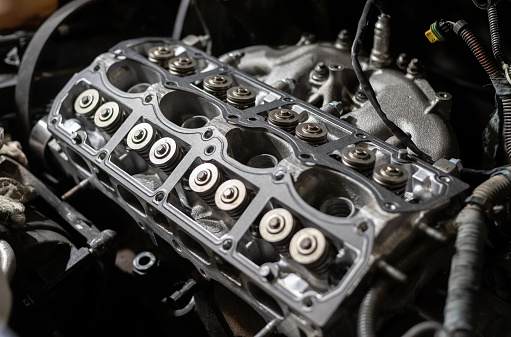 A close-up image of a cleaned car cylinder head that is still under repair. Sixteen valves. Auto service.