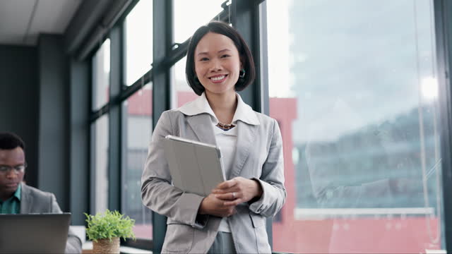 Asian woman, face and tablet by window in office for professional, legal and attorney about us for law firm. Portrait, smile and confident lawyer with digital technology for litigation consulting