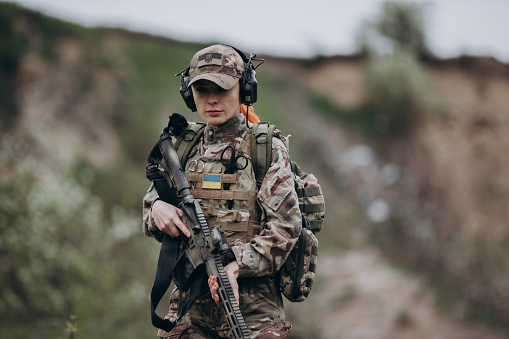 Portrait of a female Ukrainian soldier at the range
