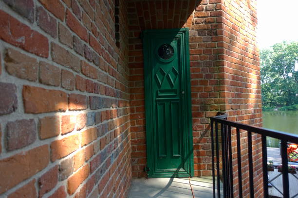 istock Green door in a brick wall 1652538361