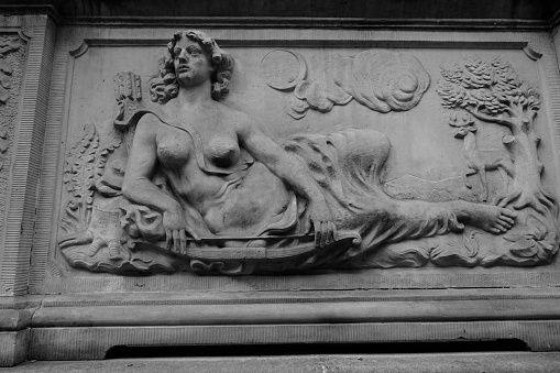 New York, NY USA - November 2, 2023 : Close-up of the bronze Alma Mater statue by Daniel Chester French in front of students sitting on the Low Library steps on Columbia University's main campus on a sunny day in Morningside Heights, NYC