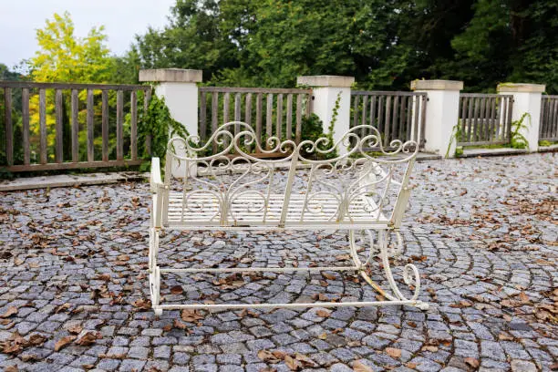 White iron bench in Victorian style on the outdoor terrace