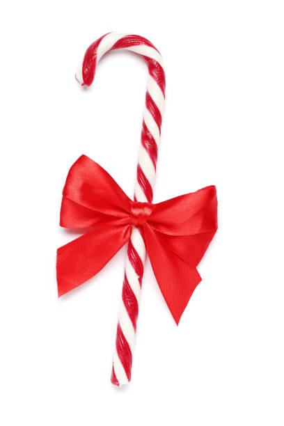 istock Tasty red candy cane with bow on white background. Festive treat 1652570472