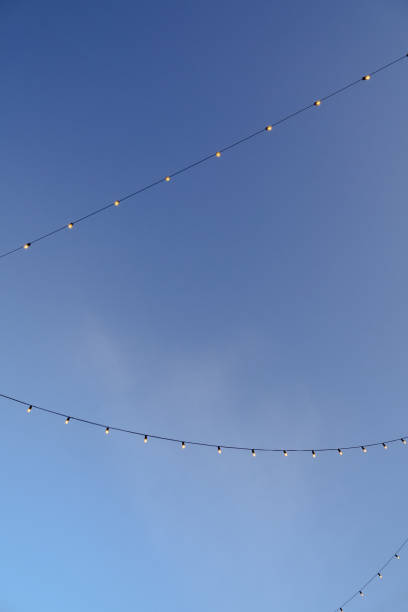 istock led lights on black cable lines in the clear blue sky. light blue background, copy space 1652571689