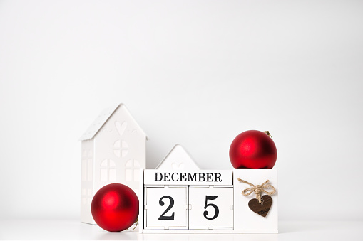 Winter background in white and red colors. Calendar with december 25 date near ornaments and decorations