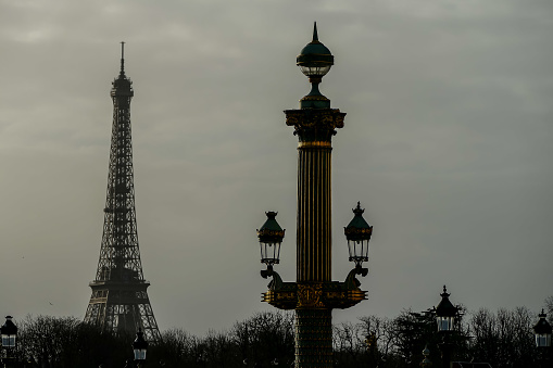 The Eiffel tower and old street lamps seen from the Jardin des Tuileries.