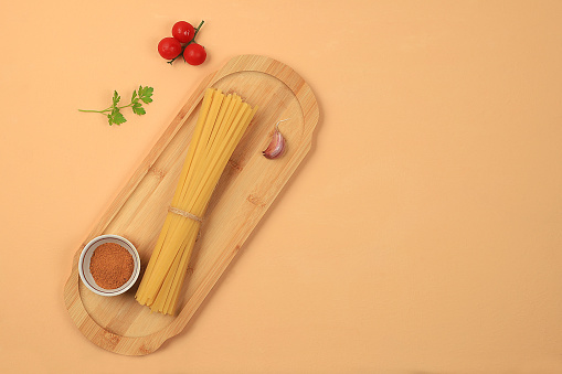 Kitchen background with ingredients for spaghetti cooking recipe, minimal cooking concept, traditional italian cuisine, business card for restaurant, cafe, shop, menu, selective focus, top view, space for text,