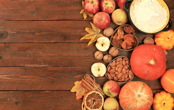 istock Kitchen background with pumpkin, apples, spices, nuts, flour, eggs with place for menu, cooking concept, ingredients for pumpkin and apple pies recipe, selective focus, top view, 1652588233