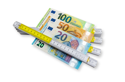 Euro banknotes in and a folding rule - with clipping path