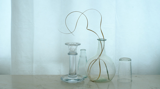 four glass objects and dried grass, home decor, negative space