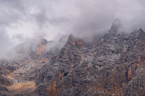 partial mountain in the European alps covered in clouds