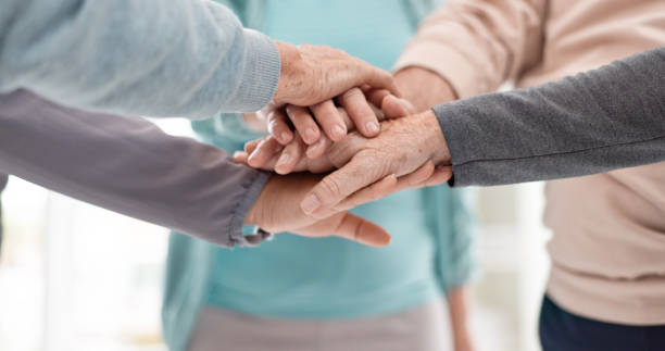 istock Fitness, high five and senior people for exercise support, collaboration and teamwork in yoga studio. Pilates, training and happy group of elderly man and women with hands together for health success 1652621472