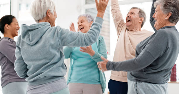 istock Fitness, hands together and senior people for exercise support, celebration and teamwork in workout class. Exercise, training goal and group of elderly man and women with high five for health success 1652621476