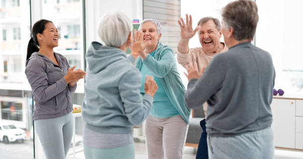 istock Fitness, hands together and senior people for exercise support, celebration and teamwork in workout class. Exercise, training goal and group of elderly man and women with high five for health success 1652621477