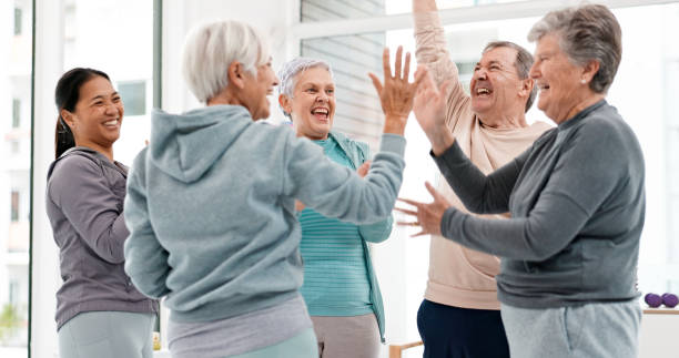 istock Fitness, hands together and senior people for exercise support, celebration and teamwork in workout class. Exercise, training goal and group of elderly man and women with high five for health success 1652621485