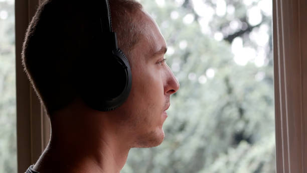 istock A Man Wearing His Headphones while Looking at the Rain from the Window 1652632739